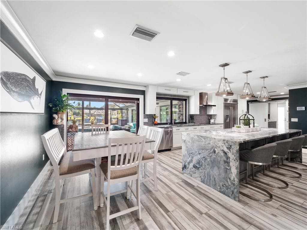 Dining space featuring crown molding, recessed lighting, and light wood finished floors