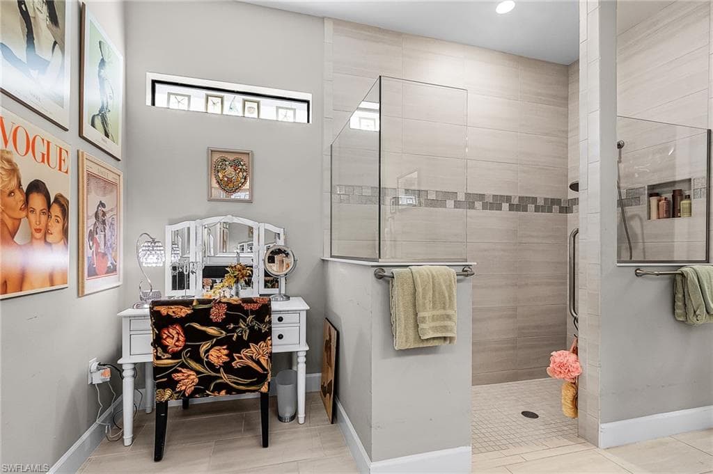 Full bath featuring baseboards and tiled shower
