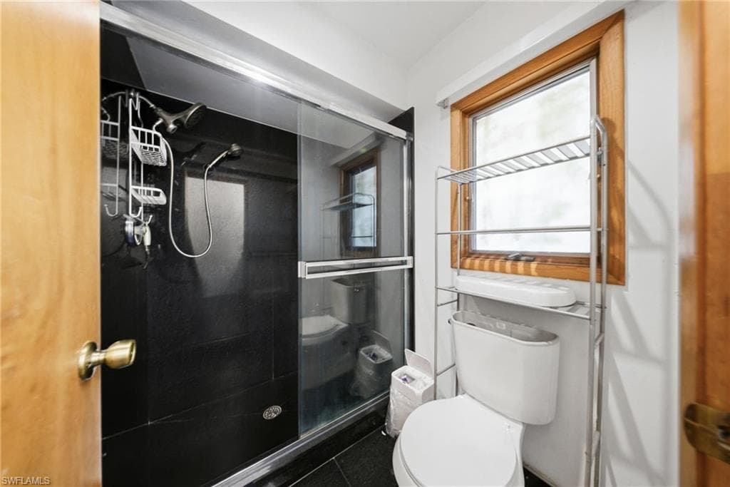 Full bathroom with a stall shower and tile patterned flooring