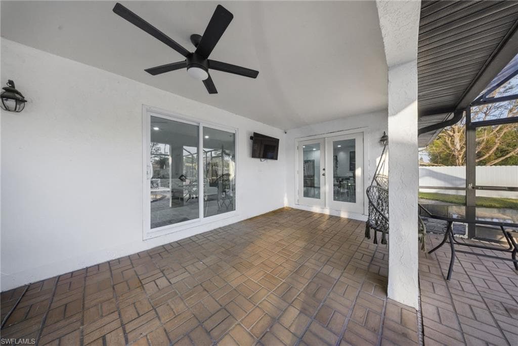 View of patio / terrace featuring french doors, ceiling fan, and a sunroom