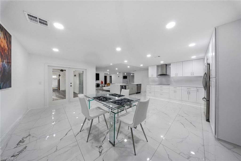 Dining room with french doors and recessed lighting