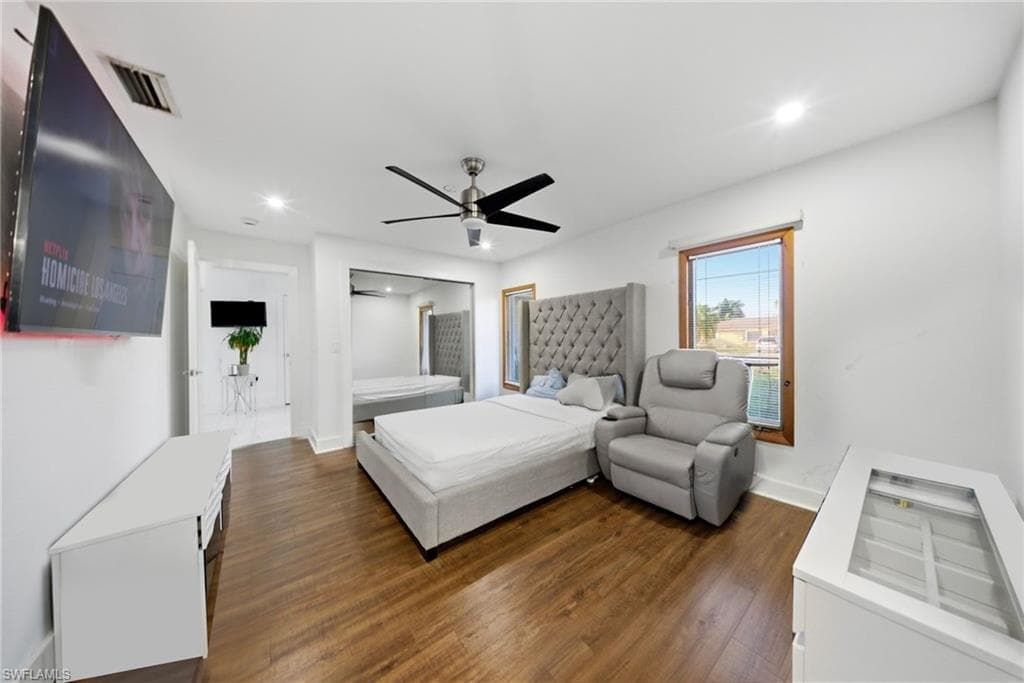 Bedroom featuring dark wood-type flooring, ceiling fan, and recessed lighting