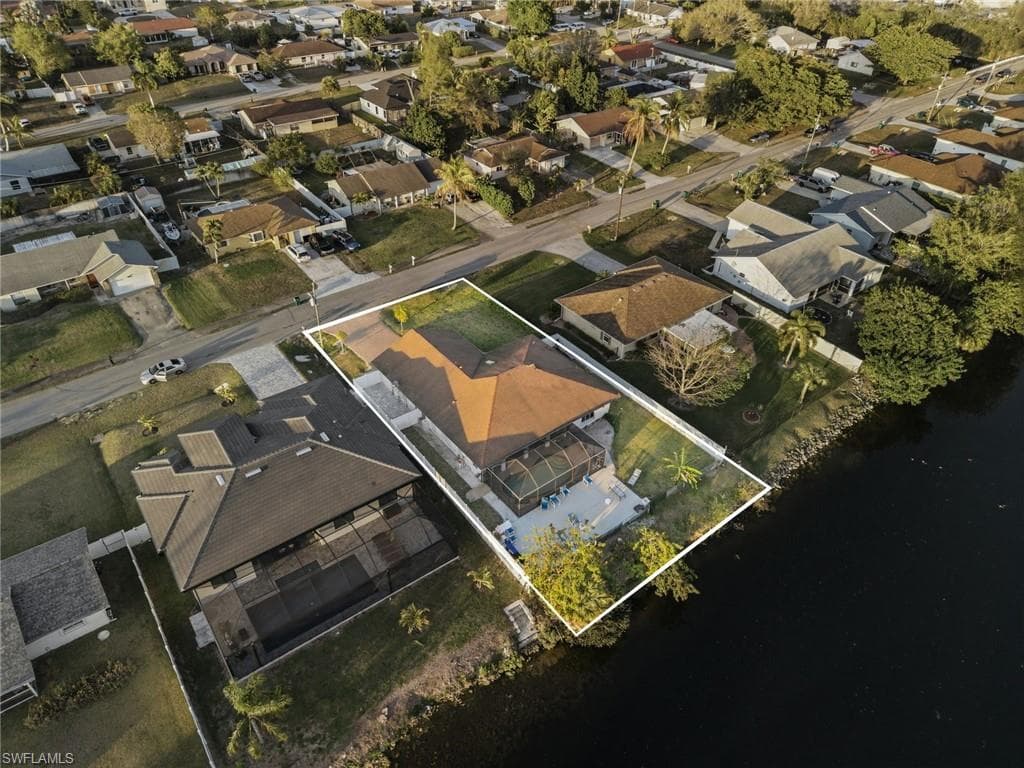 Aerial view of residential area featuring property boundaries highlighted
