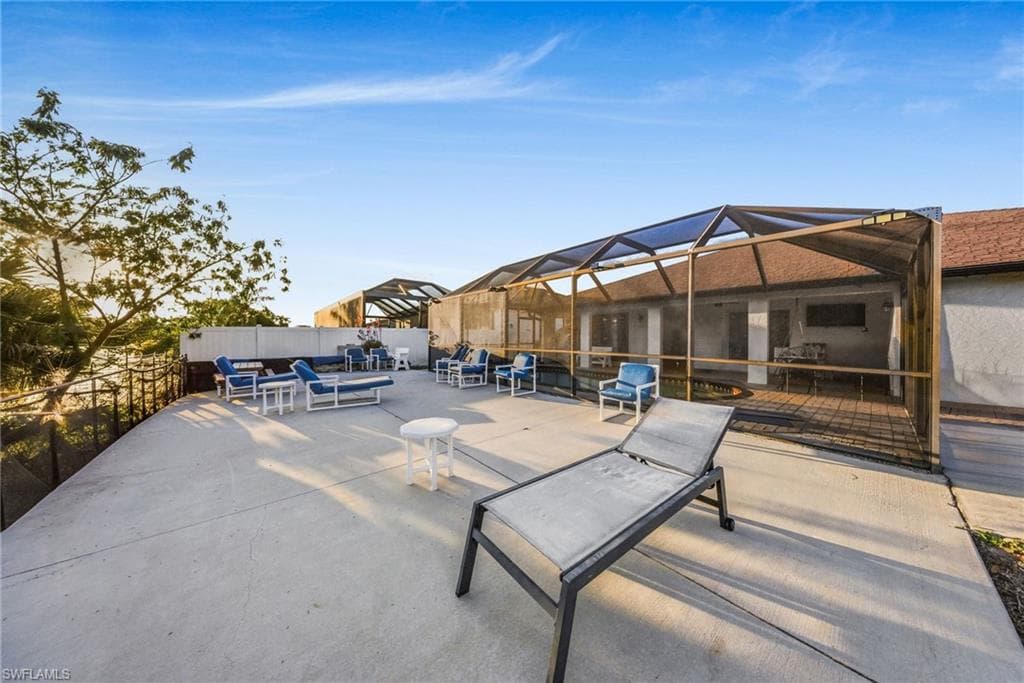 View of patio with a sunroom and glass enclosure