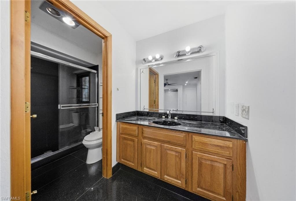 Bathroom featuring vanity and a shower stall