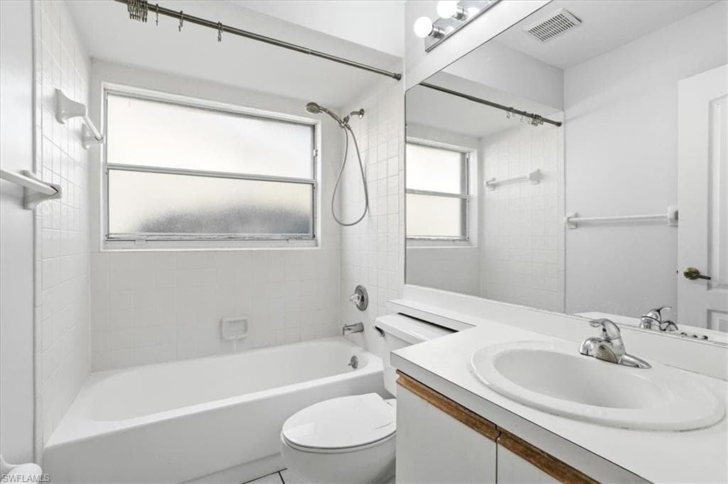 Full bath with vanity and shower / tub combination
