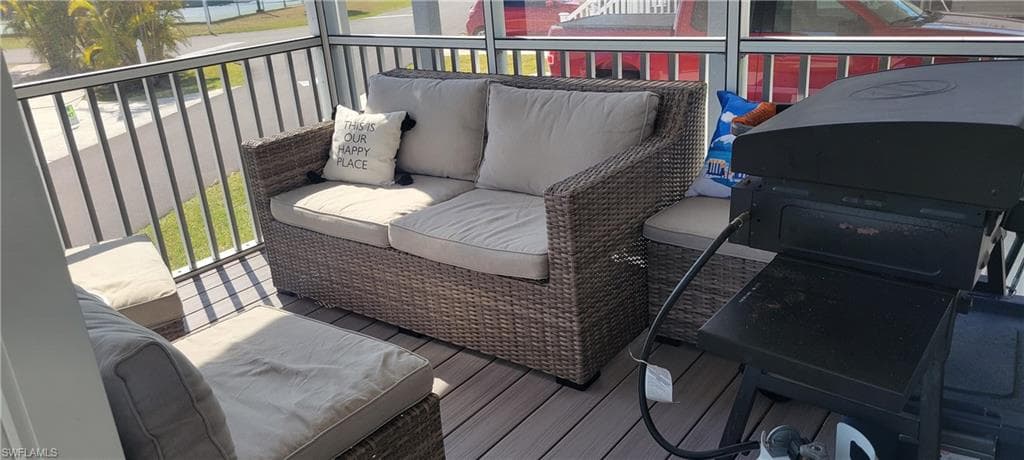 Deck featuring a sunroom and outdoor furniture