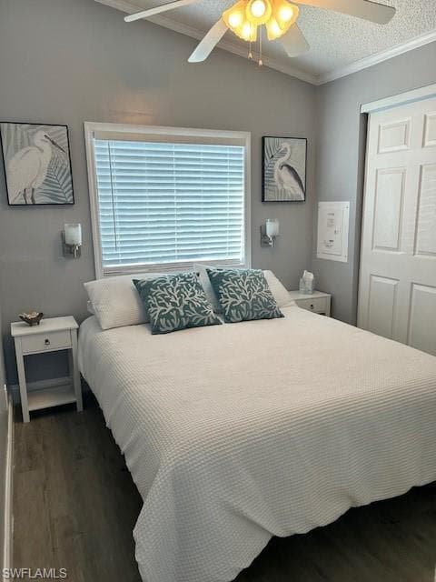 Bedroom with grey wood-style flooring, a closet, crown molding, a ceiling fan, and a textured ceiling