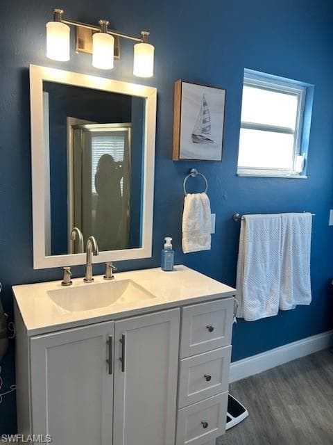 Bathroom featuring vanity and wood-type flooring