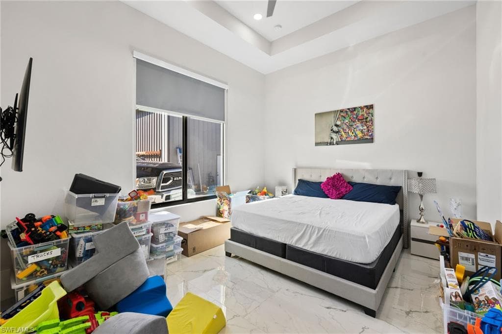 Bedroom with light marble finish flooring, recessed lighting, and ceiling fan