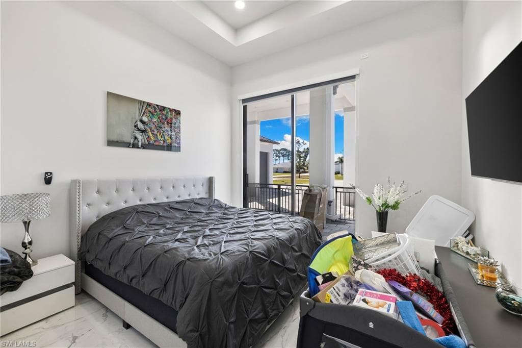 Bedroom featuring access to exterior, marble finish floors, and recessed lighting