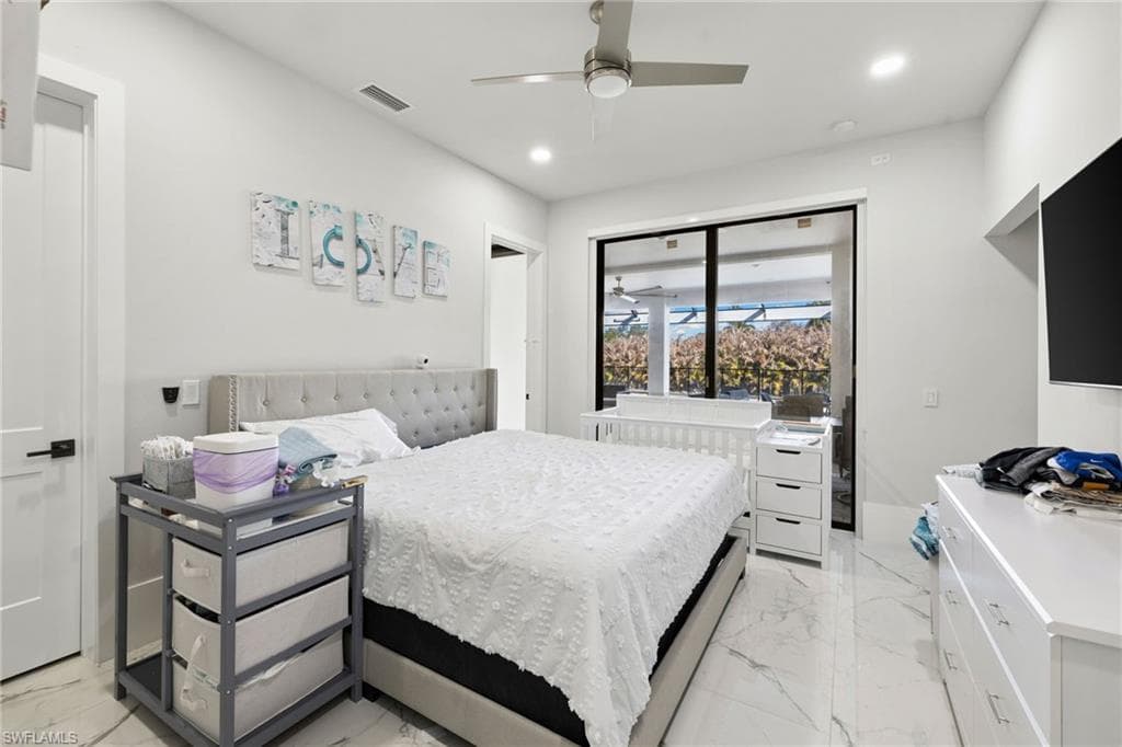 Bedroom featuring recessed lighting, ceiling fan, and light marble finish flooring
