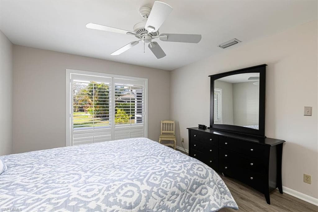 Primary Bedroom with a ceiling fan and light wood-style floors