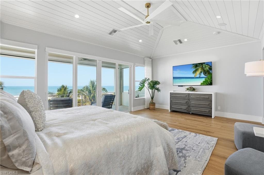 Bedroom with a vaulted wood ceiling, light wood-type flooring, recessed lighting, and access to exterior - Virtually Edited Image