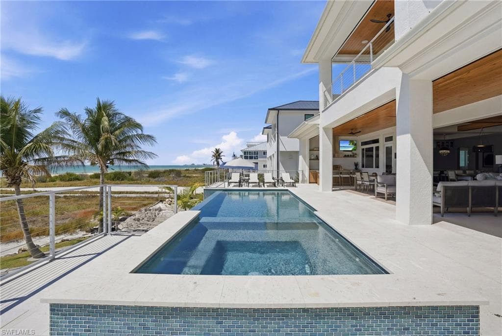 Relaxing pool / spa with a patio, a balcony, and outdoor lounge area - Virtually Edited Image