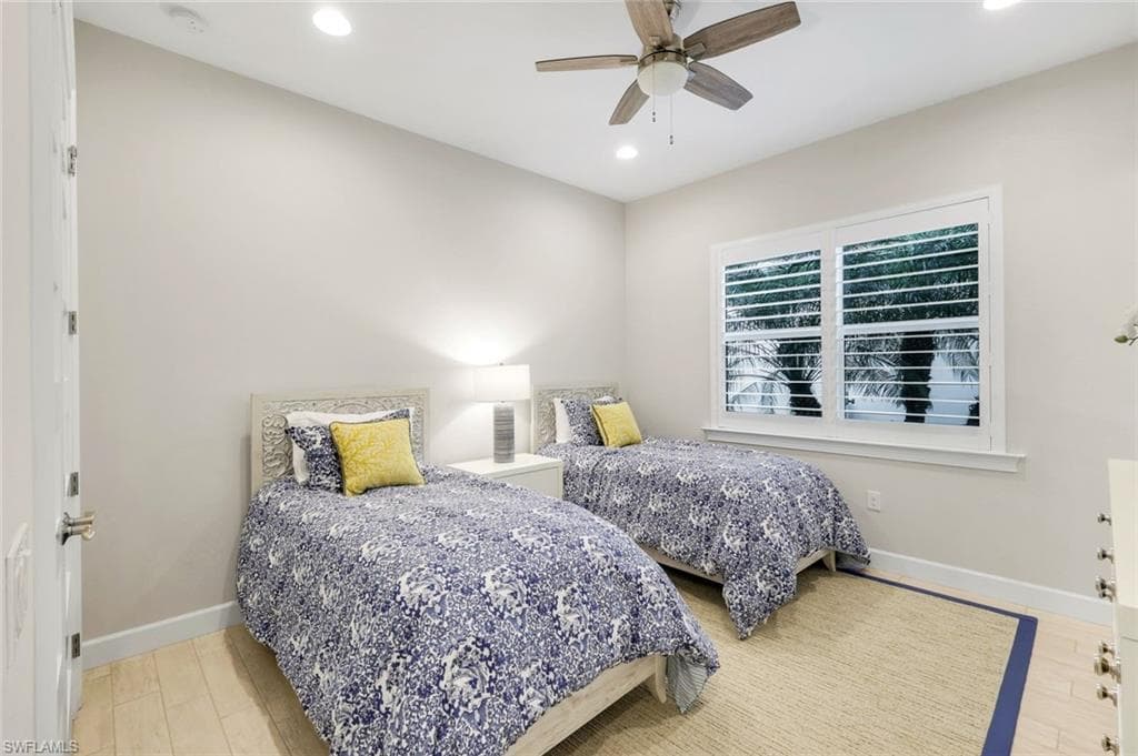 Bedroom with ceiling fan, recessed lighting, and light wood finished floors