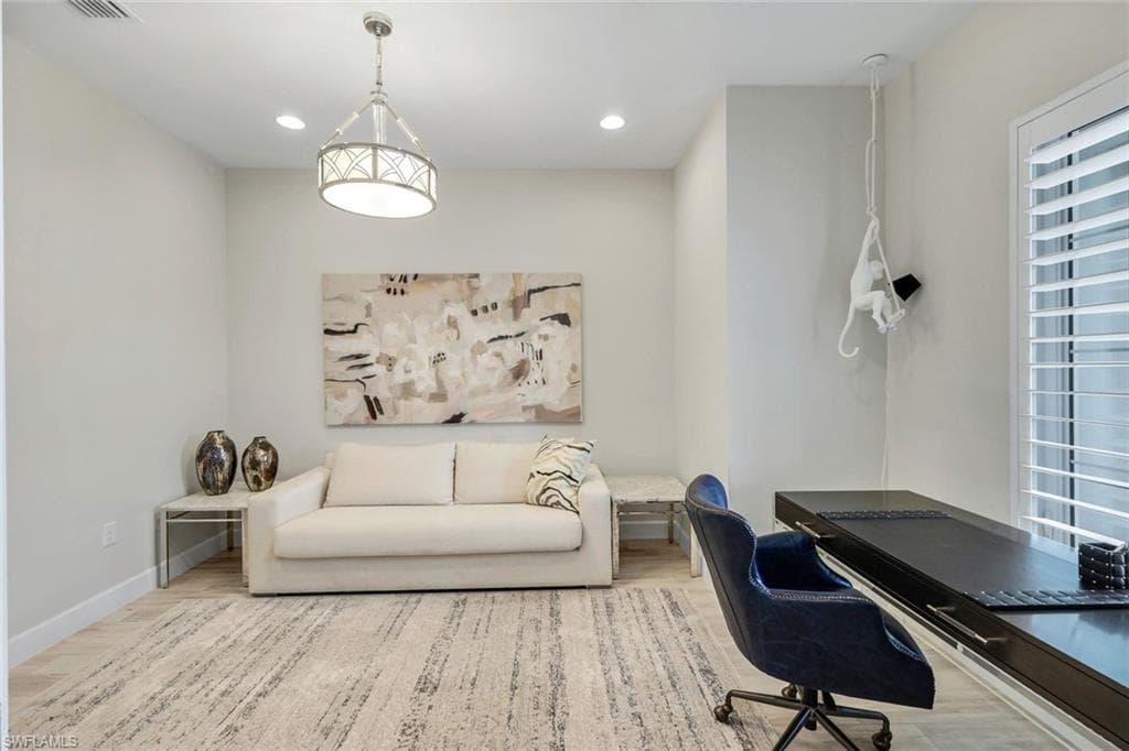 Office space featuring light wood finished floors and recessed lighting