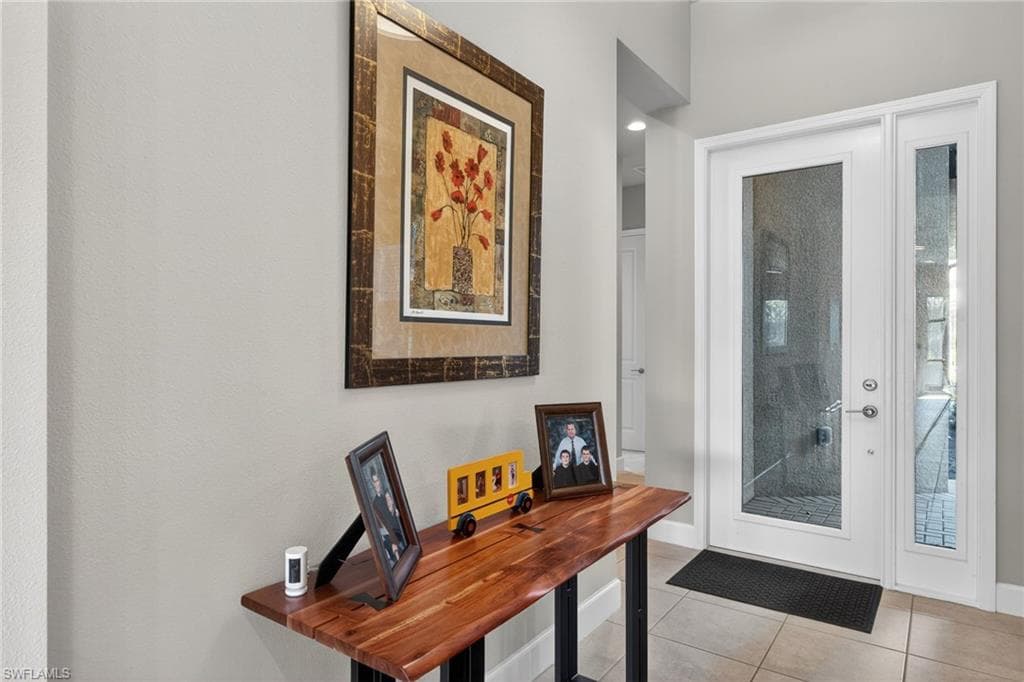 Entryway featuring tile patterned flooring and baseboards
