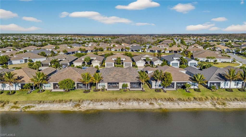 Aerial perspective of suburban area with a nearby body of water