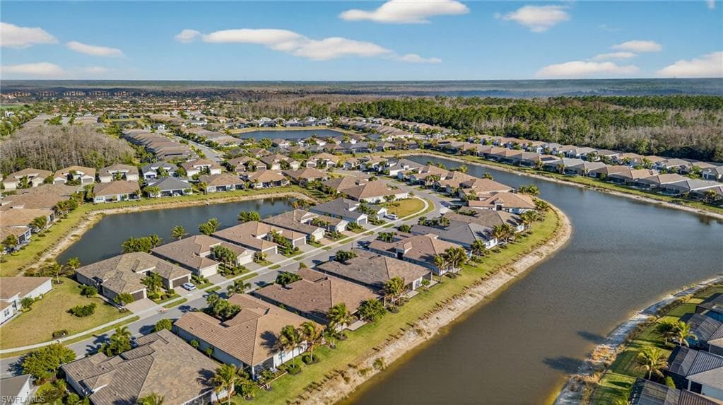 Aerial perspective of suburban area featuring a nearby body of water
