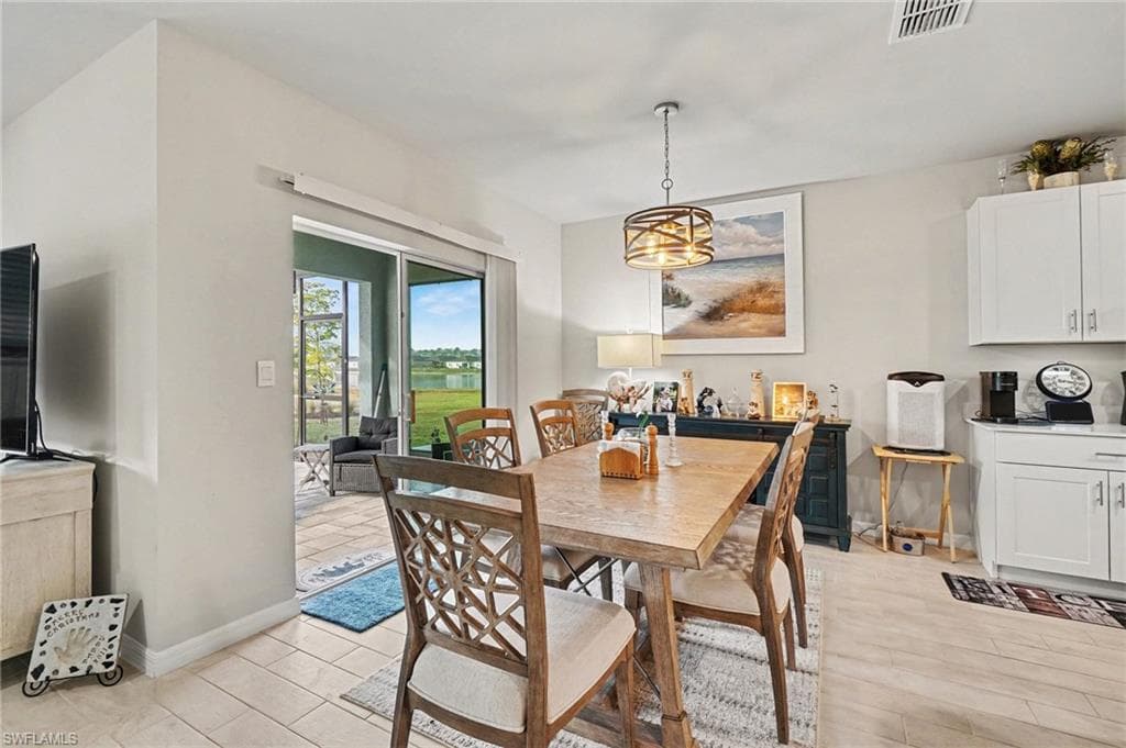 Dining space with light wood finished floors and a water view