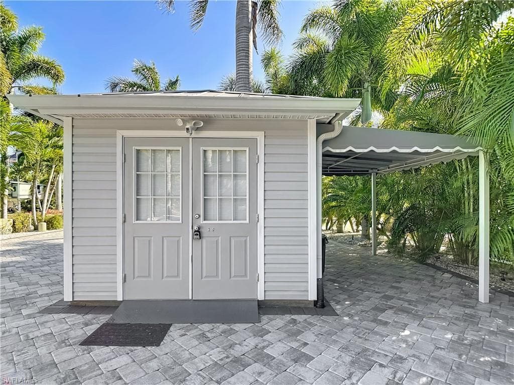 View of outdoor structure featuring an attached carport