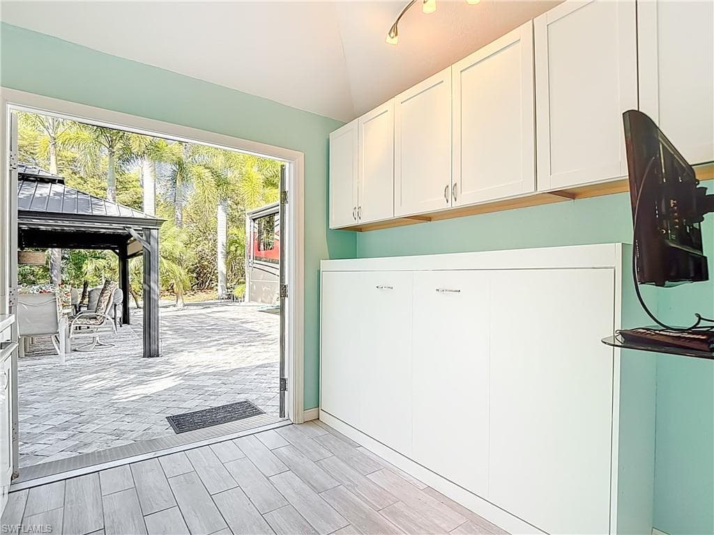 Laundry area with wood tiled floors and ceiling