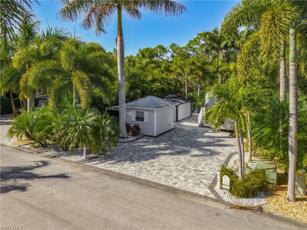 View of front facade with decorative driveway and a garage