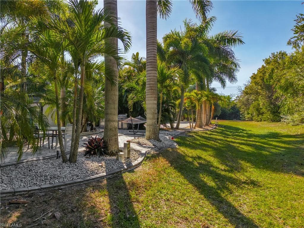 View of green lawn with a patio