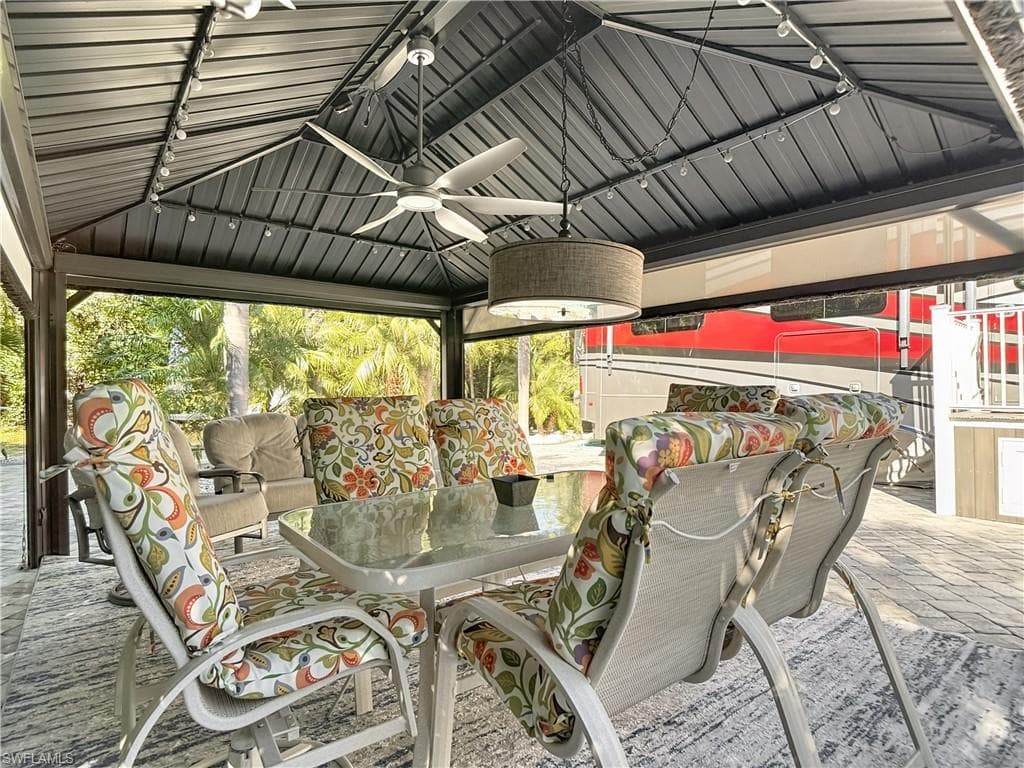 Deck featuring ceiling fan, outdoor dining space, a gazebo, and a patio area