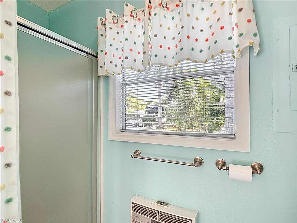 Bathroom view of a shower with shower curtain