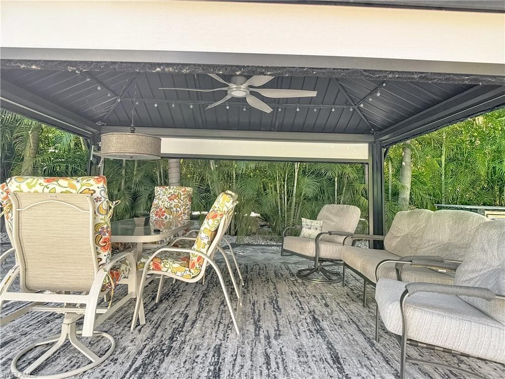 ceiling fan and outdoor dining space