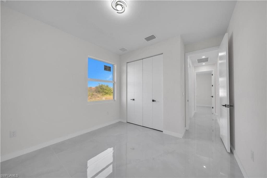 Unfurnished bedroom featuring baseboards and a closet