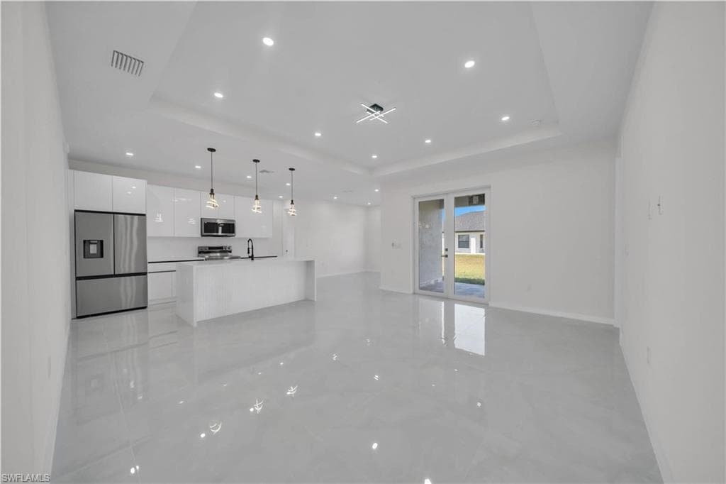 Unfurnished living room with recessed lighting and baseboards