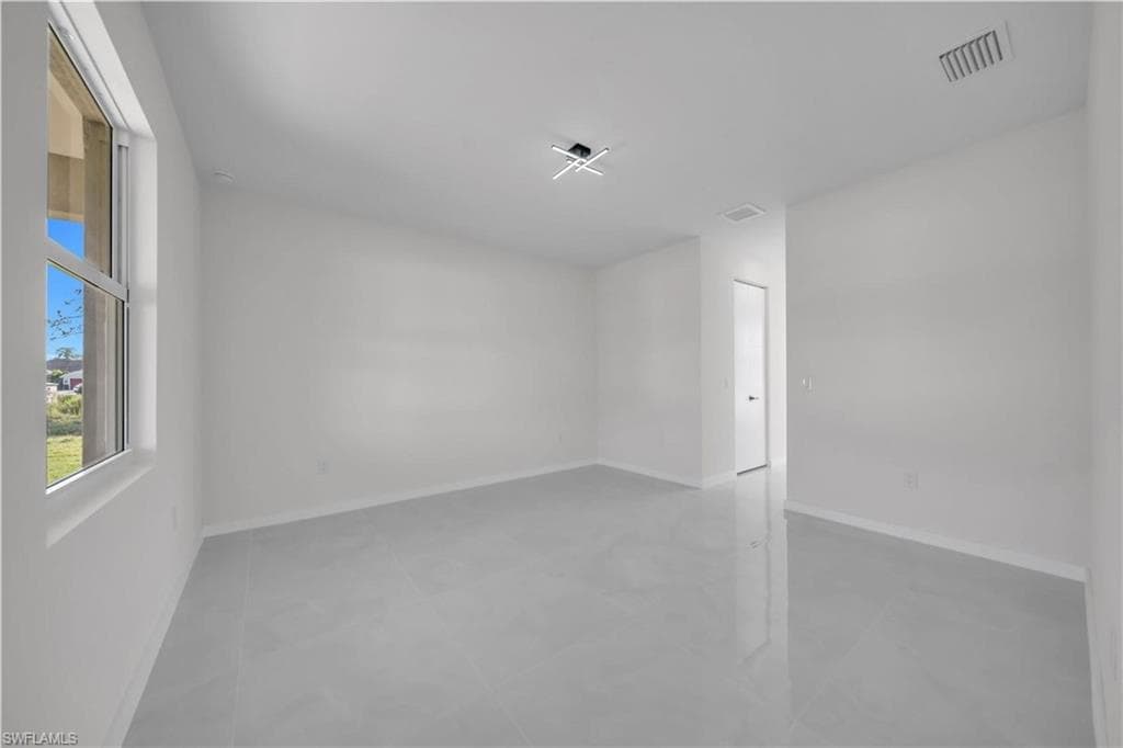 Unfurnished room with baseboards