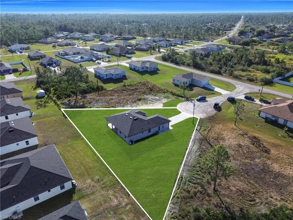 Aerial perspective of suburban area with a forest