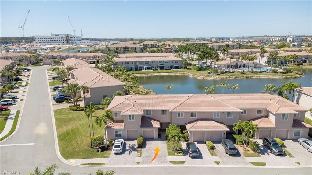 Aerial perspective of suburban area featuring a nearby body of water