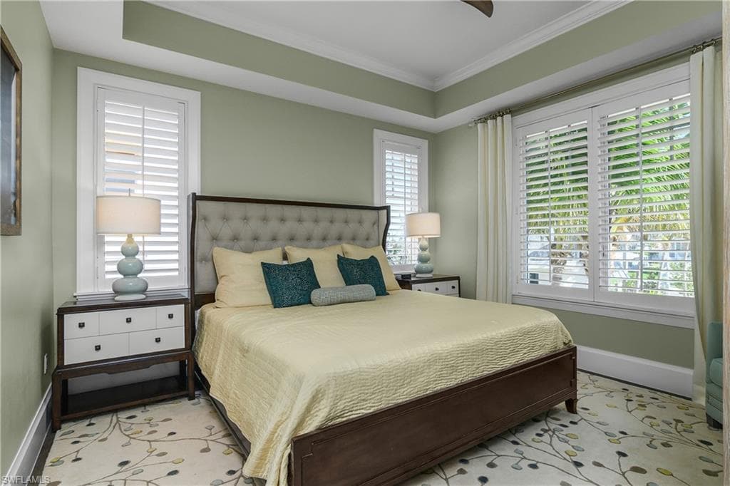 Bedroom featuring baseboards and crown molding