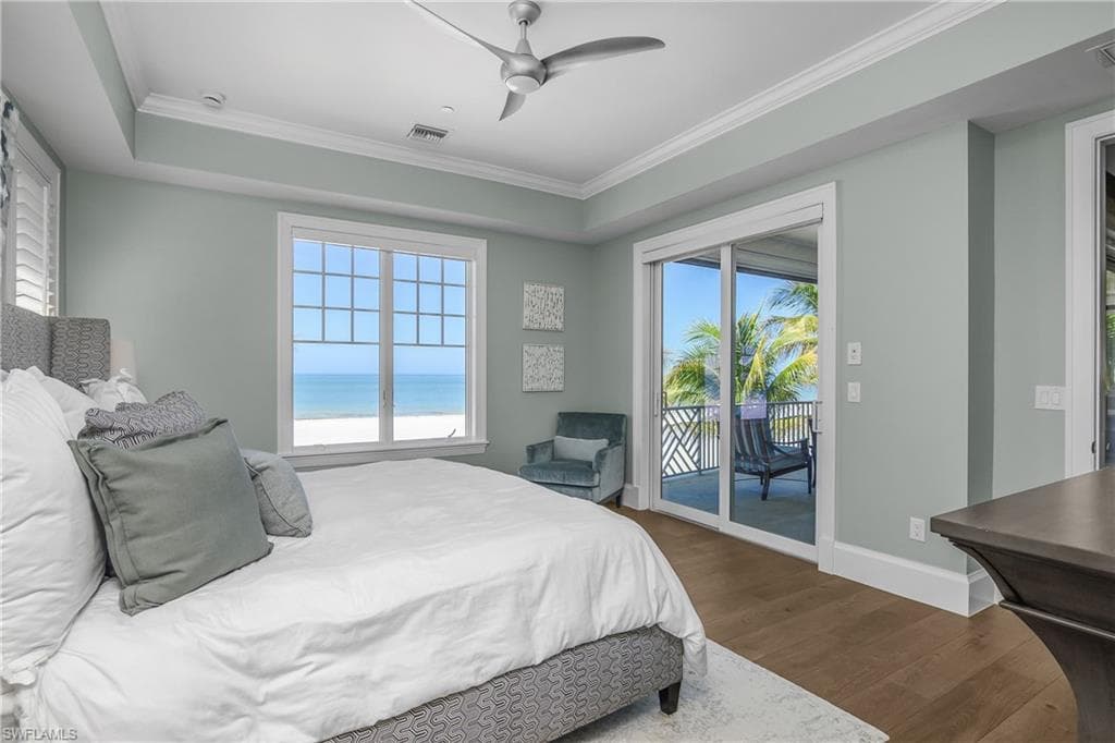 Bedroom with dark wood finished floors, ceiling fan, access to outside, and ornamental molding