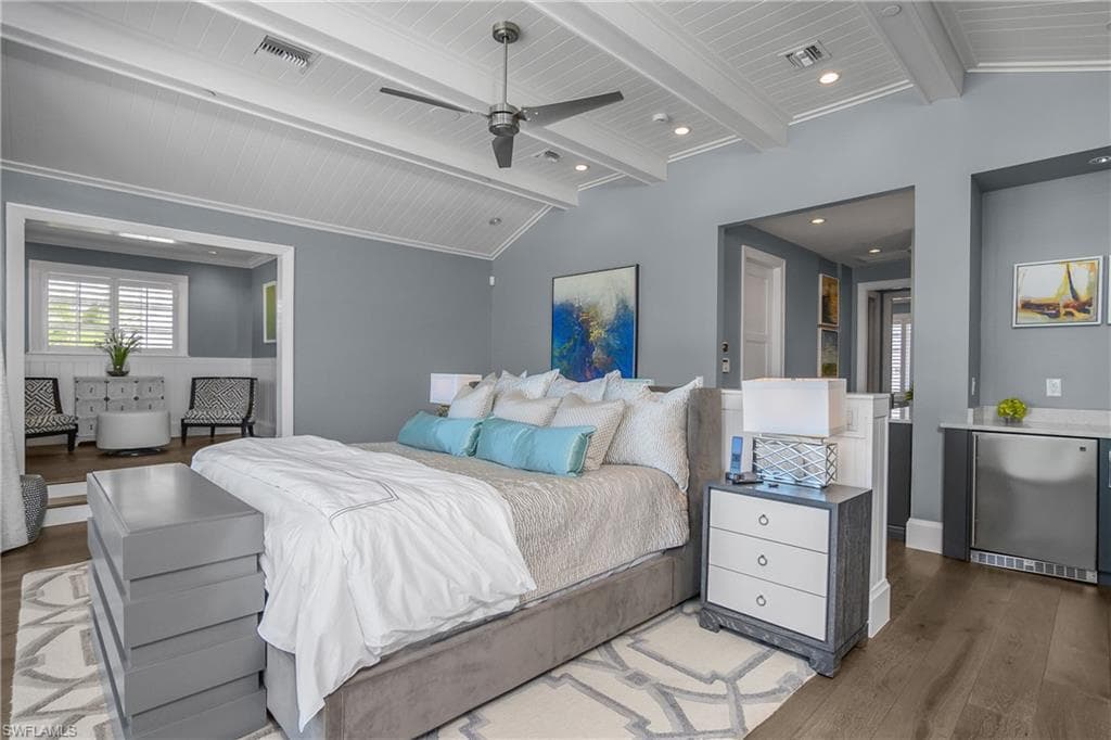 Bedroom featuring lofted ceiling with beams, stainless steel refrigerator, light wood-style floors, a ceiling fan, and recessed lighting
