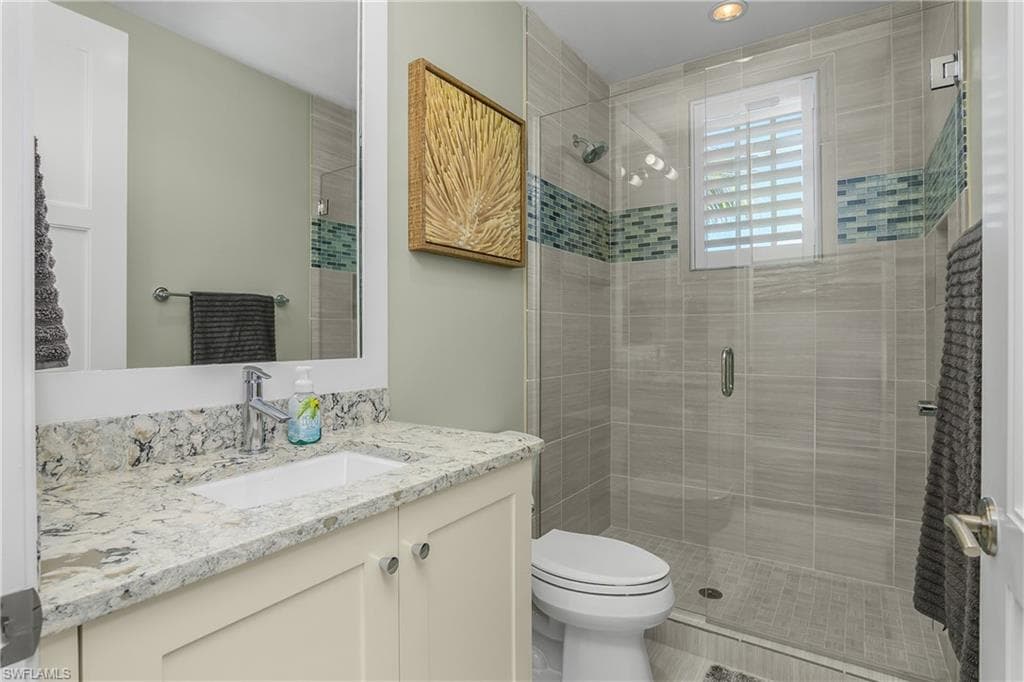 Bathroom featuring vanity and a shower stall