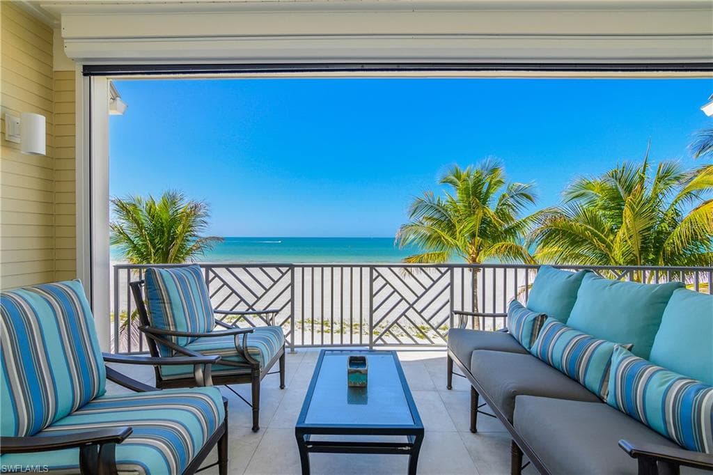 View of patio with outdoor furniture and view of water and beach