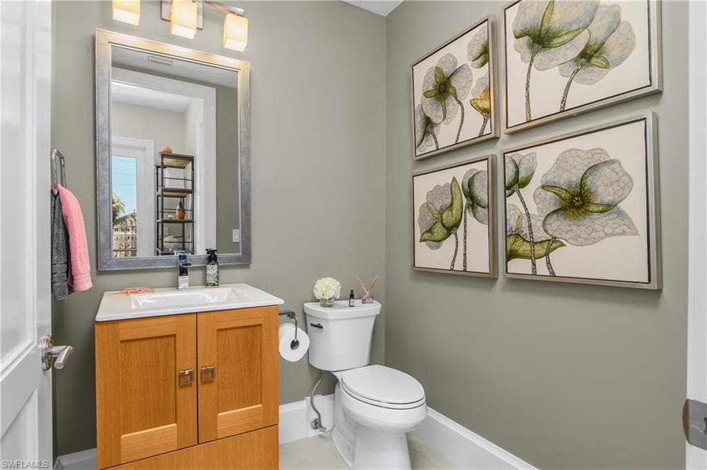 Half bath featuring toilet and vanity