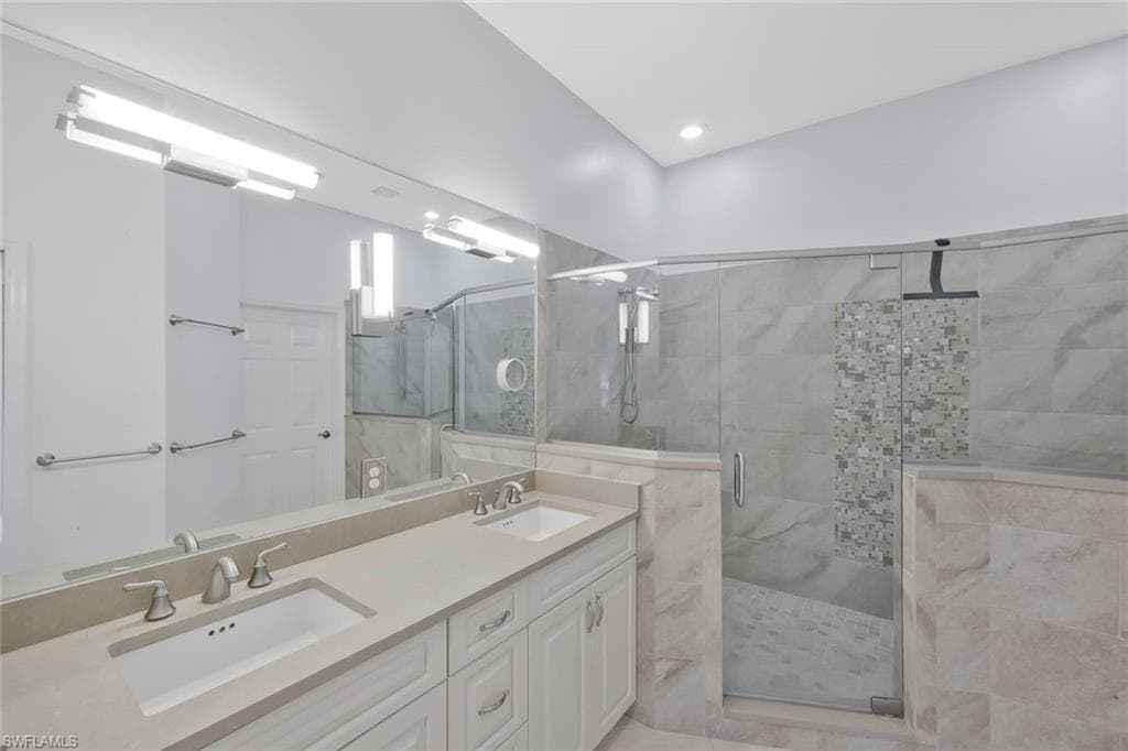 Beautifully updated primary bathroom featuring modern finishes and a spacious walk in shower.
