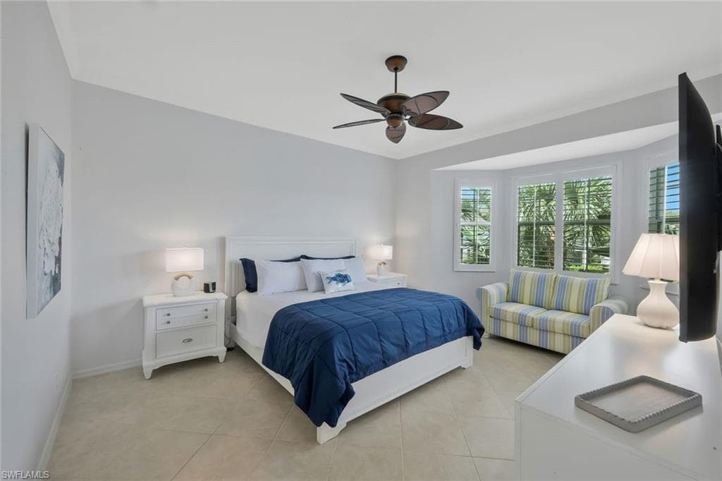 Spacious primary suite with high ceilings, large windows, and private access to the lanai for peaceful morning views.