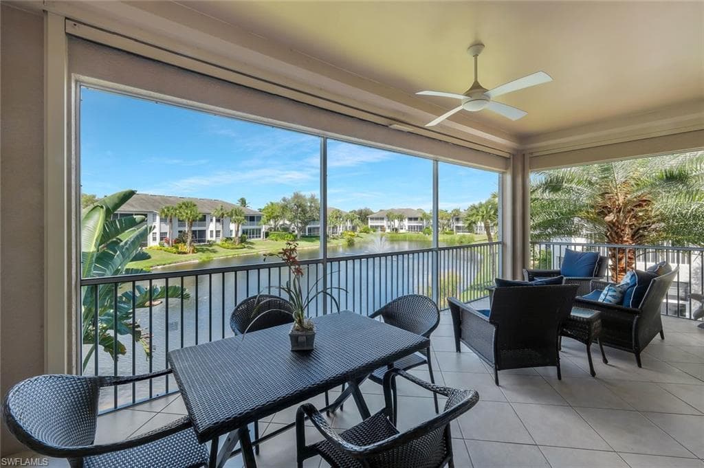 Screened lanai overlooking the peaceful lake and water feature, offering the perfect setting for morning coffee or evening relaxation.