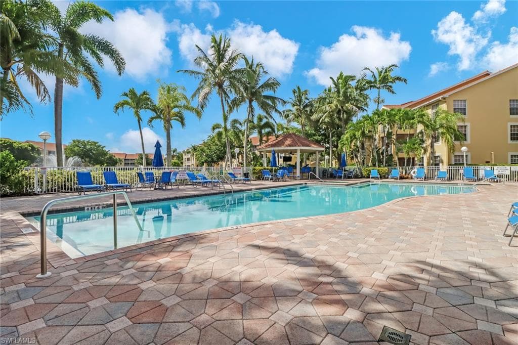 Community pool with a patio area and a gazebo