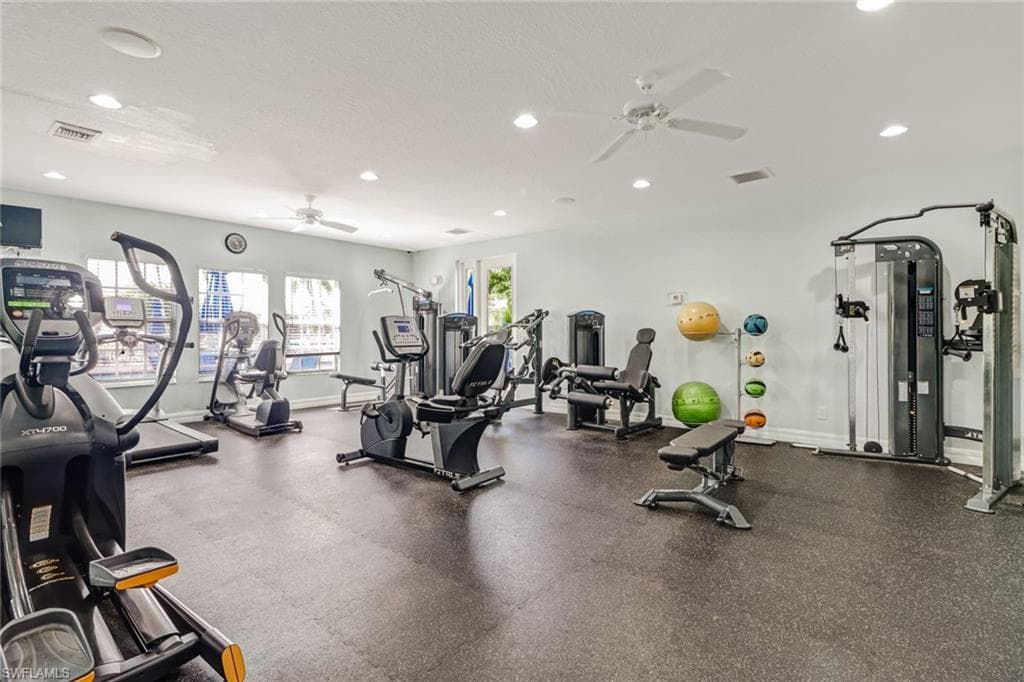 Workout area featuring a ceiling fan and recessed lighting