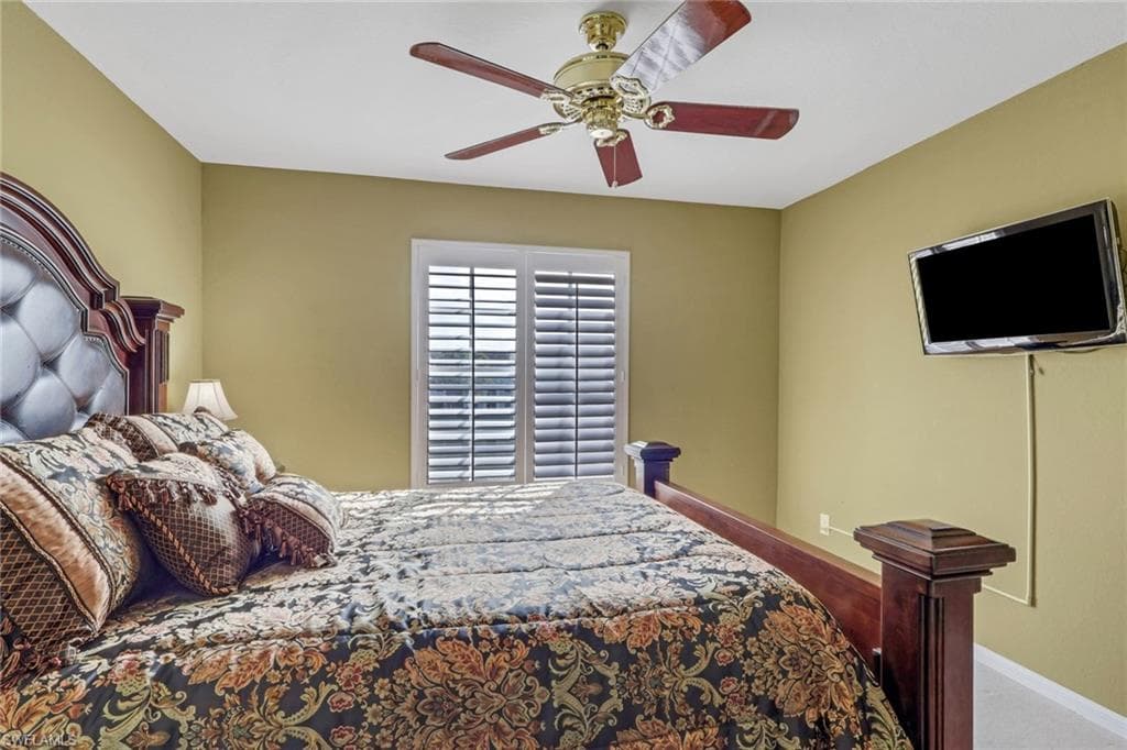 Primary bedroom with plantation shutters and lake view