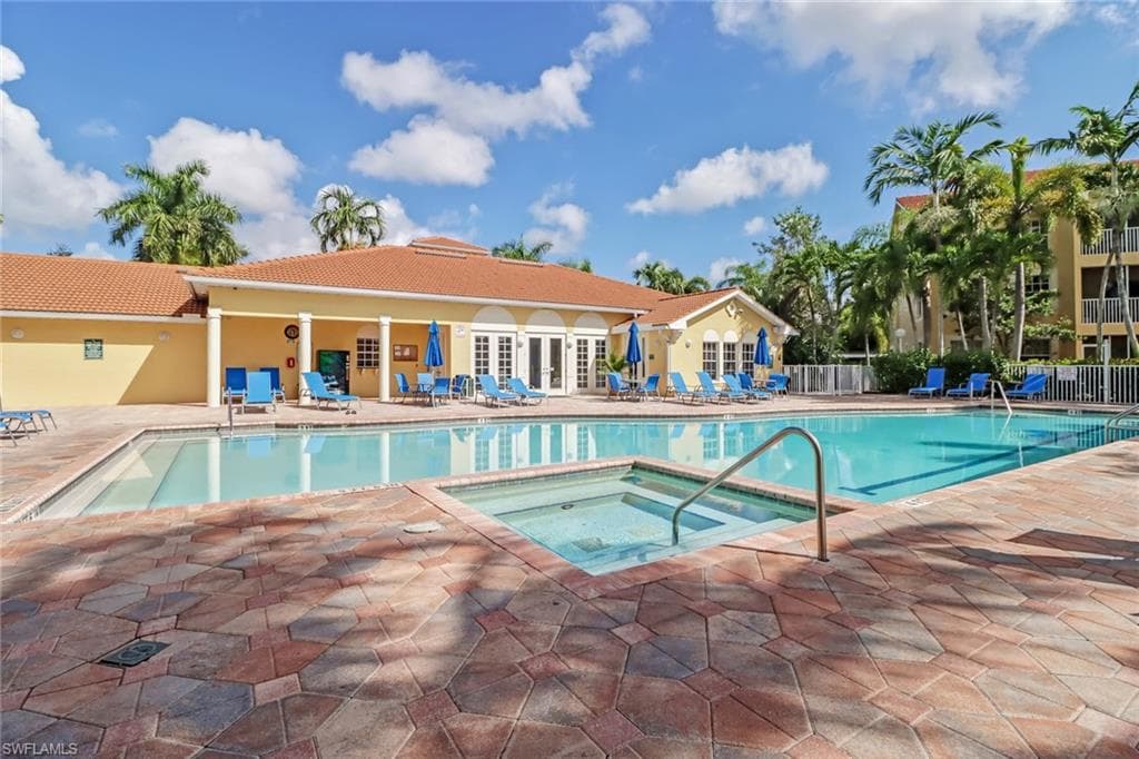 Community pool with a community hot tub, a patio area, and french doors
